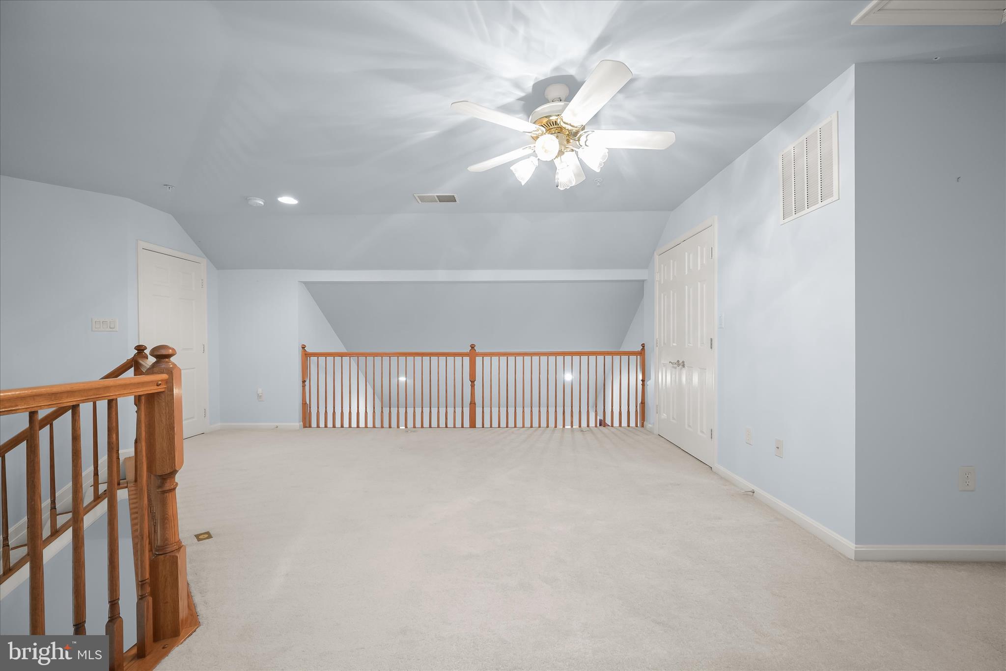 6428 Hickory Overlook, Unit 71 Columbia, MD 21044 - Photo 48 of 63 a view of an empty room with a chandelier fan