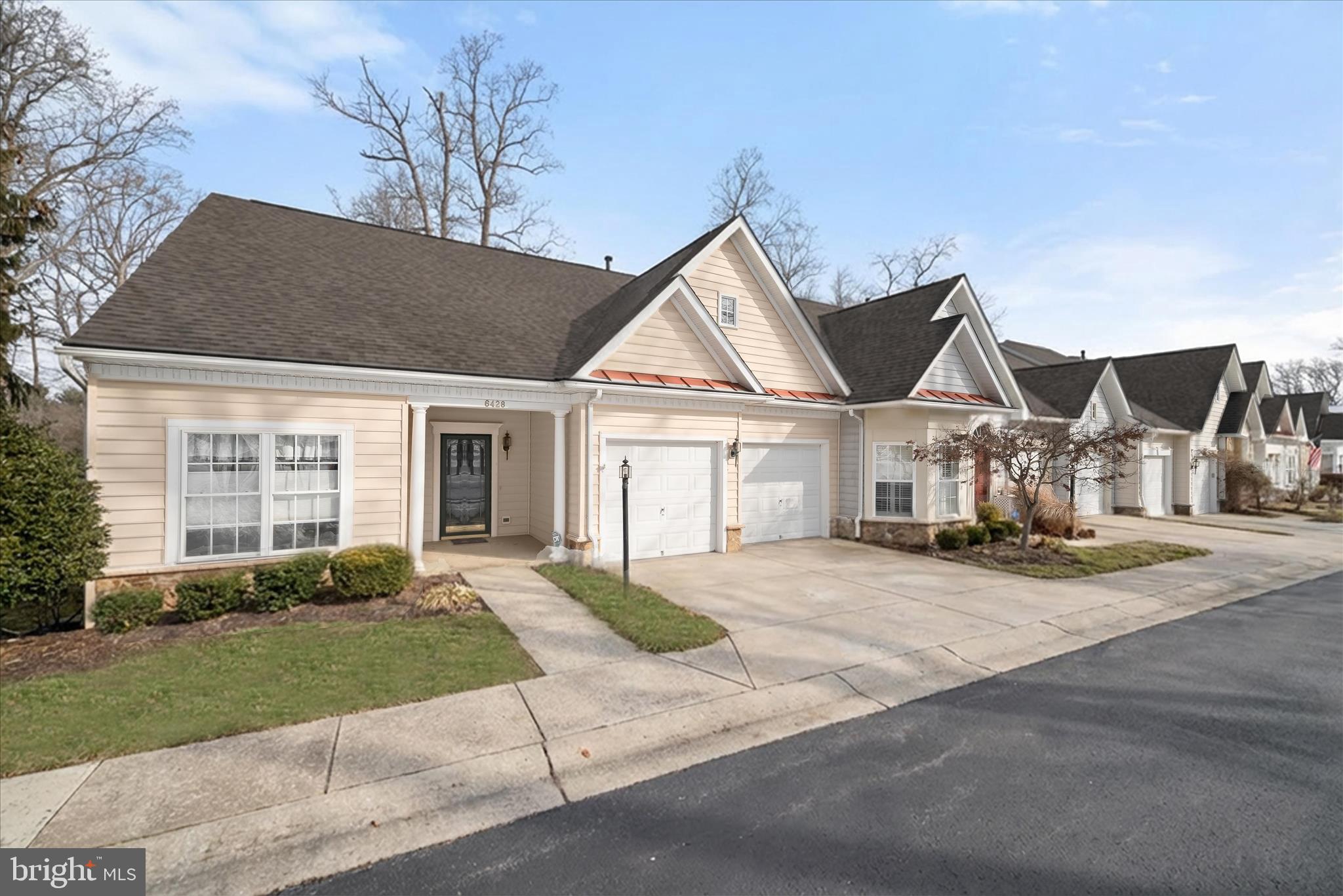 6428 Hickory Overlook, Unit 71 Columbia, MD 21044 - Photo 55 of 63 a front view of a house with a yard and garage
