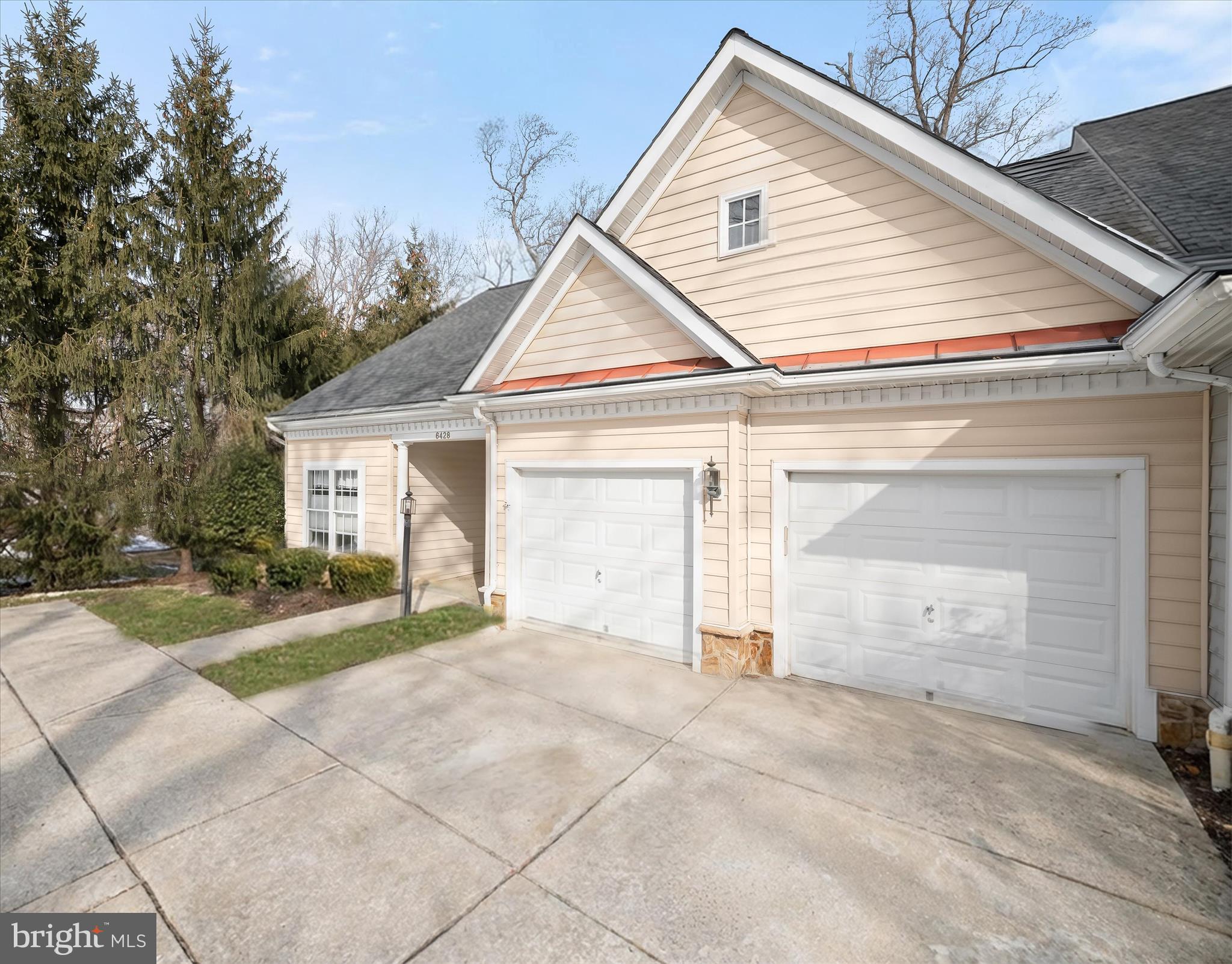 6428 Hickory Overlook, Unit 71 Columbia, MD 21044 - Photo 57 of 63 a view of a house with a yard and garage