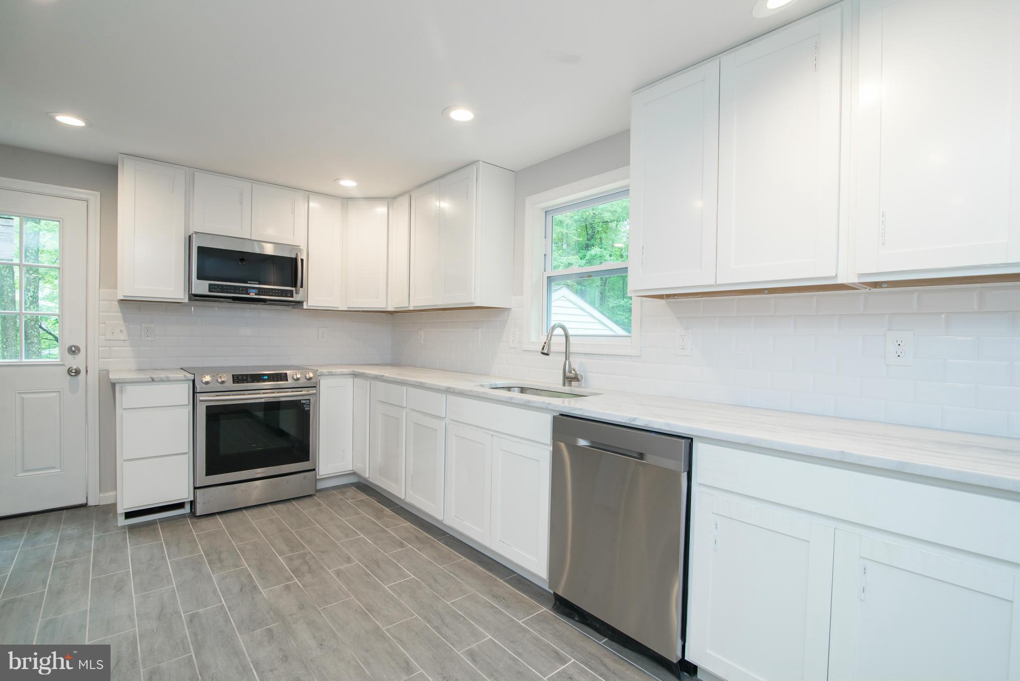 7132 Barry Road Alexandria, VA 22315 - Photo 8 of 28 a kitchen with cabinets appliances and a window