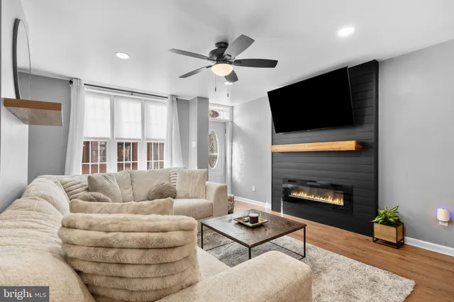 a living room with furniture and a wooden floor