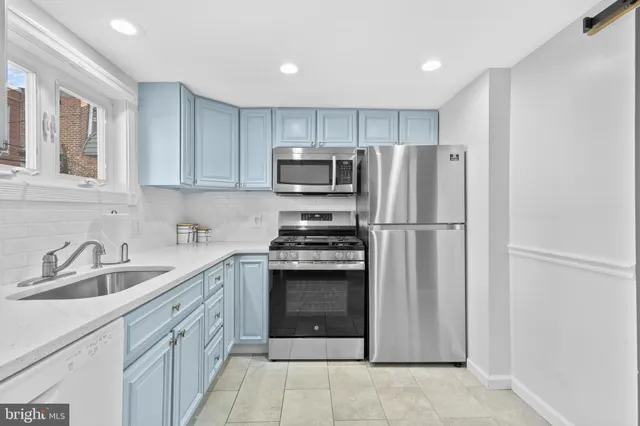 a kitchen with stainless steel appliances granite countertop a refrigerator sink and cabinets