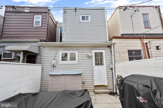 a view of roof deck with couch and chairs