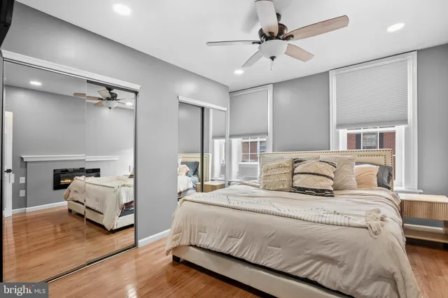 a bathroom with a toilet sink vanity and mirror