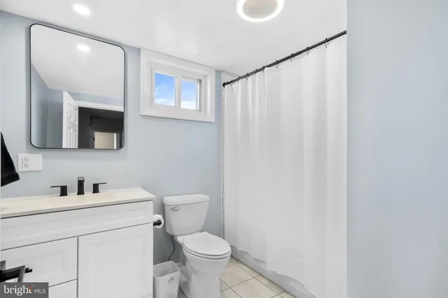 a view of a dining room with furniture a kitchen and chandelier
