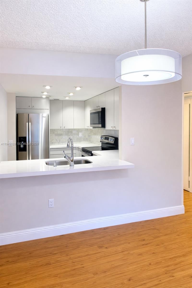 9033 Southwest 123rd Court, Unit 105 Miami, FL 33186 - Photo 7 of 11 a view of kitchen with microwave and window