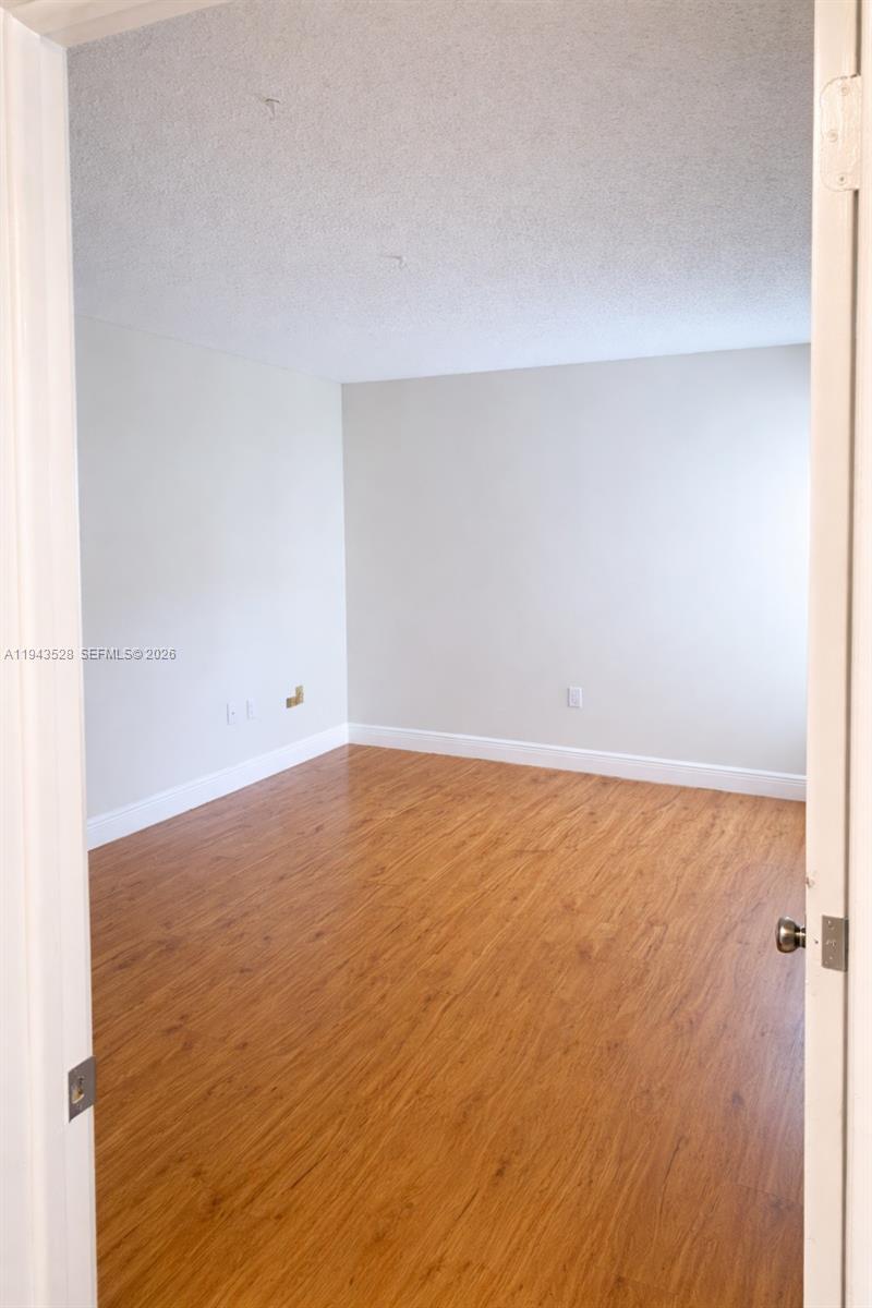 9033 Southwest 123rd Court, Unit 105 Miami, FL 33186 - Photo 9 of 11 a view of an empty room
