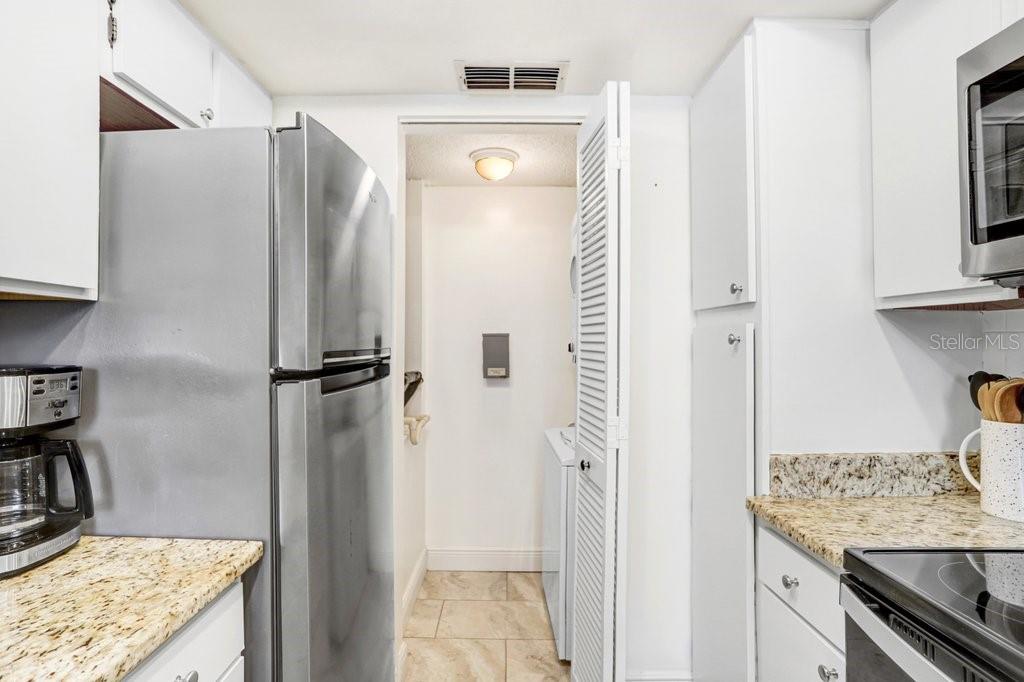 13602 South Village Drive, Unit 1205 Tampa, FL 33618 - Photo 13 of 51 a bathroom with a granite countertop sink and a mirror