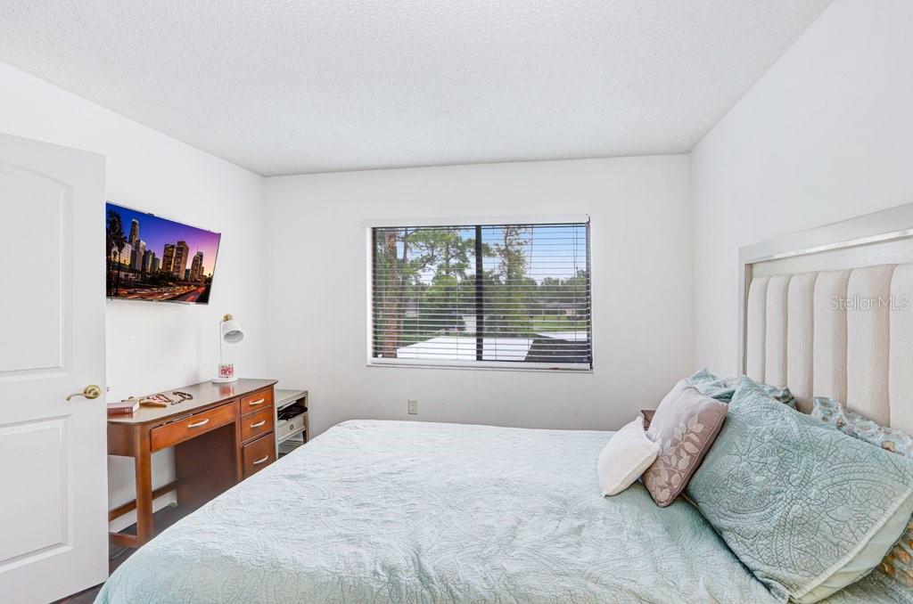 13602 South Village Drive, Unit 1205 Tampa, FL 33618 - Photo 17 of 51 a bedroom with a bed and a flat screen tv
