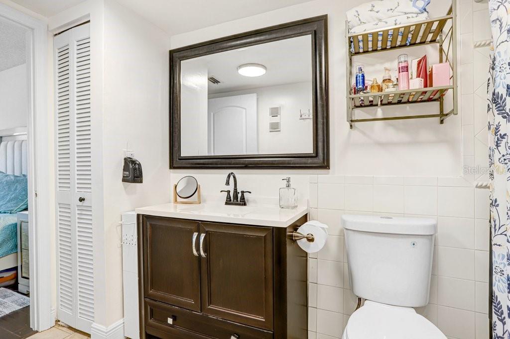 13602 South Village Drive, Unit 1205 Tampa, FL 33618 - Photo 19 of 51 a bathroom with a toilet sink and mirror