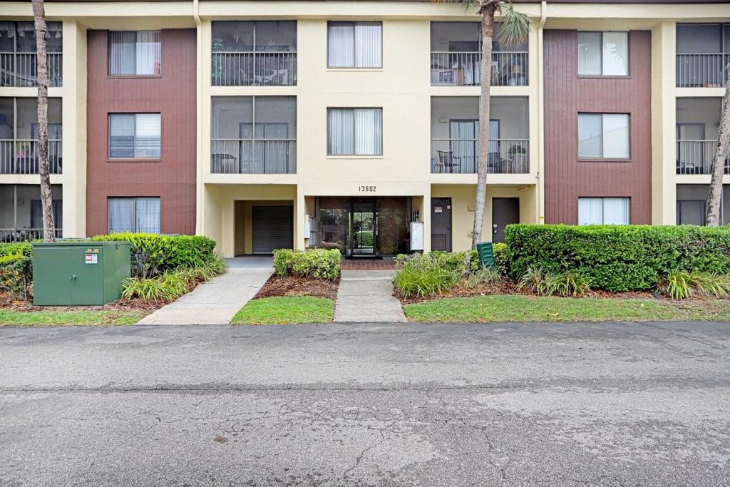 13602 South Village Drive, Unit 1205 Tampa, FL 33618 - Photo 2 of 51 a small yard in front of a brick building