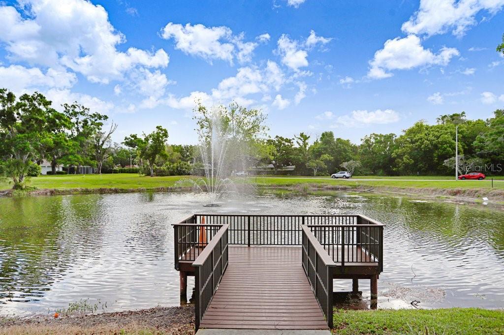 13602 South Village Drive, Unit 1205 Tampa, FL 33618 - Photo 35 of 51 a view of a lake with a wooden deck and a lake view