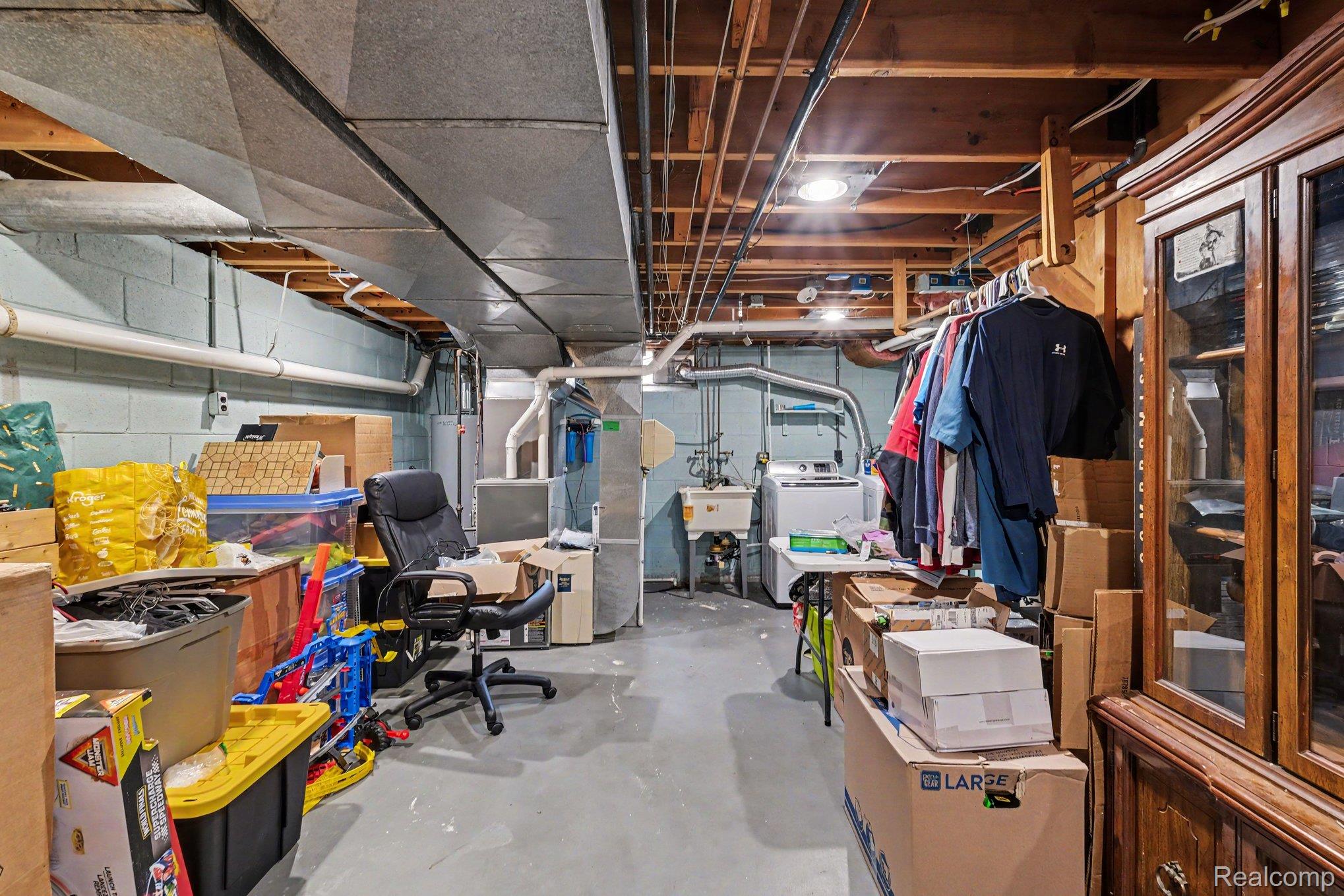 5449 South Genesee Road Grand Blanc, MI 48439 - Photo 14 of 18 Basement utility area featuring a concrete floor, exposed ductwork, and ceiling joists