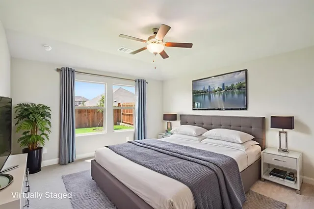 a bedroom with a large bed and a chandelier