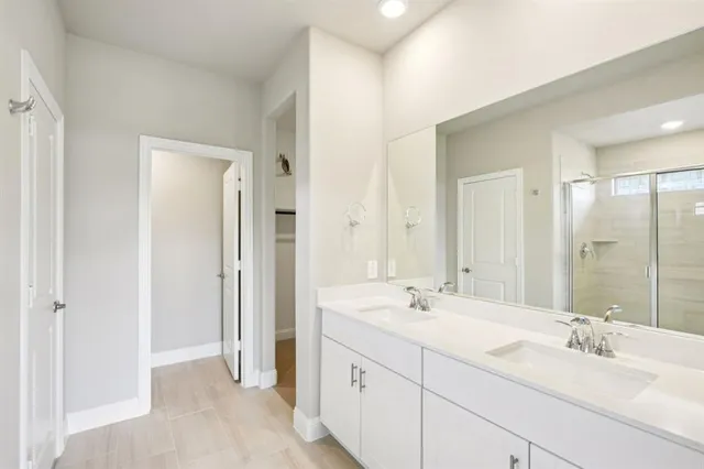a bathroom with a double vanity sink mirror and double