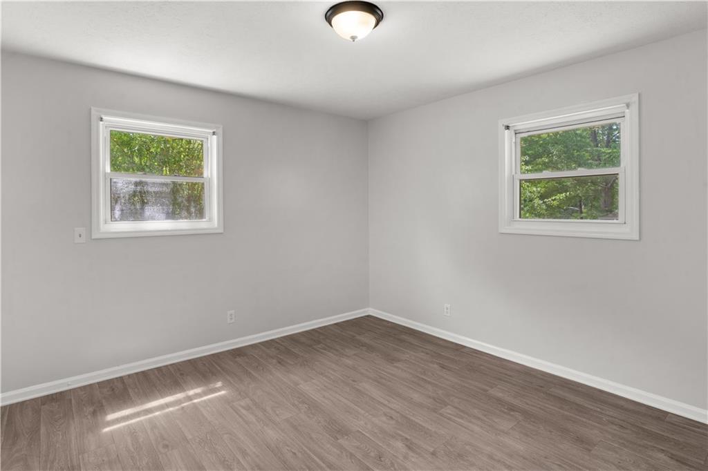 4776 Duncan Drive Powder Springs, GA 30127 - Photo 11 of 24 a view of an empty room with wooden floor and a window