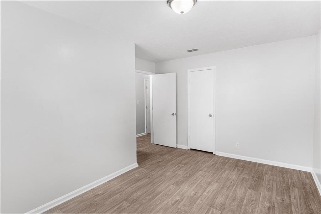 4776 Duncan Drive Powder Springs, GA 30127 - Photo 13 of 24 a view of an empty room with wooden floor