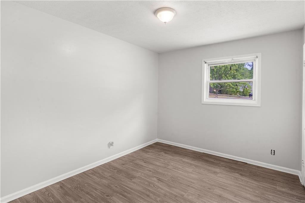 4776 Duncan Drive Powder Springs, GA 30127 - Photo 20 of 24 an empty room with wooden floor and window