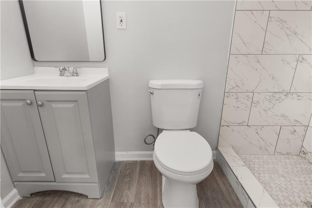 4776 Duncan Drive Powder Springs, GA 30127 - Photo 21 of 24 a bathroom with a toilet sink and mirror
