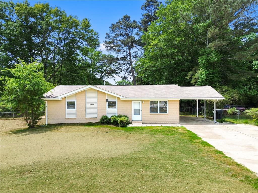 4776 Duncan Drive Powder Springs, GA 30127 - Photo 6 of 24 a front view of a house with a garden