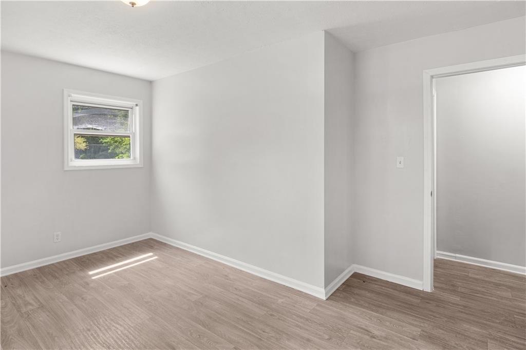 4776 Duncan Drive Powder Springs, GA 30127 - Photo 10 of 24 an empty room with wooden floor and windows
