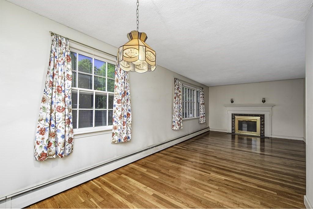 7 Rand Road Salem, MA 01970 - Photo 11 of 24 an empty room with wooden floor and windows