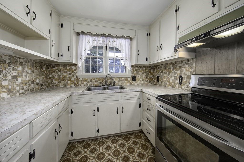7 Rand Road Salem, MA 01970 - Photo 12 of 24 a kitchen with a sink stove and cabinets