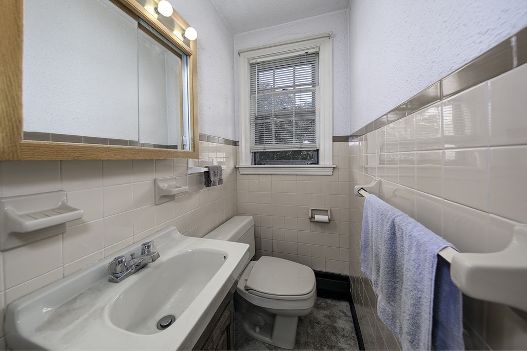 7 Rand Road Salem, MA 01970 - Photo 14 of 24 a bathroom with a sink a toilet and a mirror