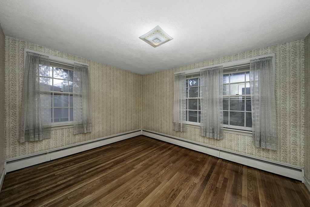 7 Rand Road Salem, MA 01970 - Photo 15 of 24 a view of an empty room with wooden floor and a window