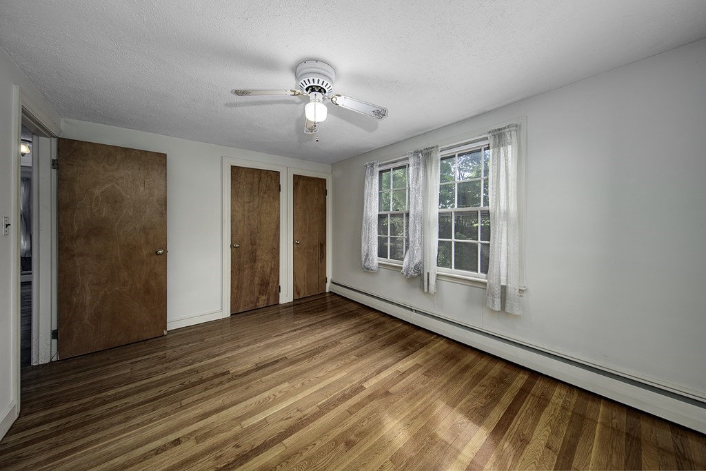 7 Rand Road Salem, MA 01970 - Photo 17 of 24 a view of an empty room with wooden floor and a window