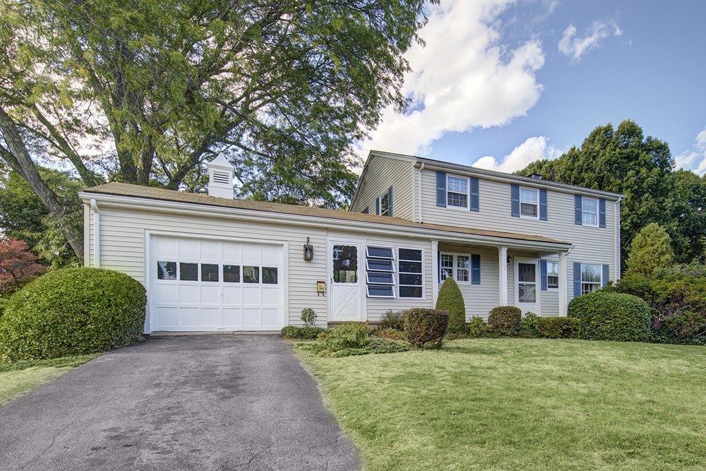 7 Rand Road Salem, MA 01970 - Photo 4 of 24 a view of a white house with a small yard and a large tree