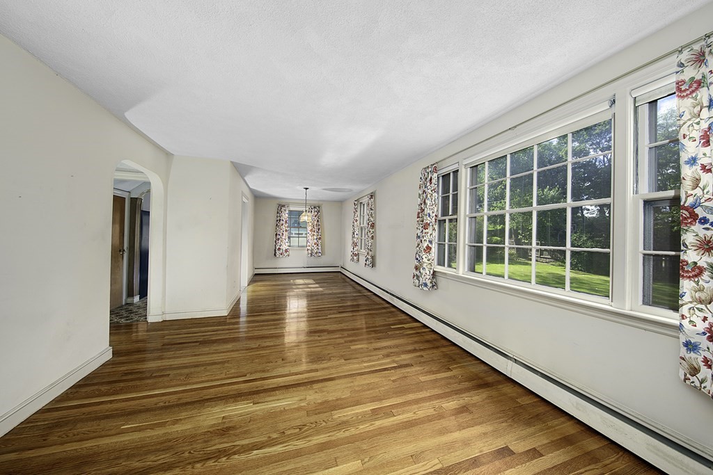 7 Rand Road Salem, MA 01970 - Photo 7 of 24 a view of an empty room with wooden floor and a window