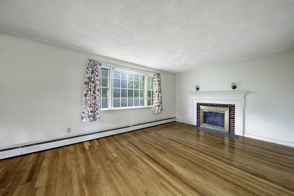 7 Rand Road Salem, MA 01970 - Photo 8 of 24 a view of an empty room with wooden floor and a window