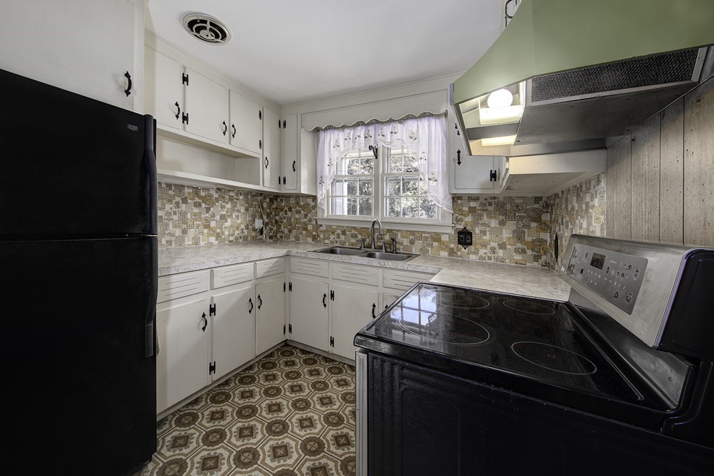 7 Rand Road Salem, MA 01970 - Photo 10 of 24 a kitchen with a sink stove and refrigerator