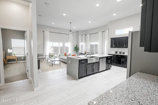 a kitchen with a refrigerator and a counter top space