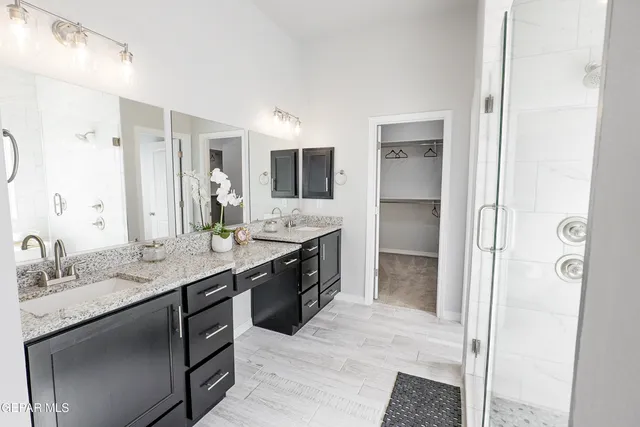 a bathroom with a granite countertop sink mirror and double