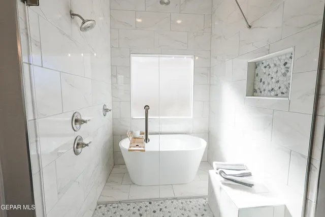 a white tub sitting next to a white sink