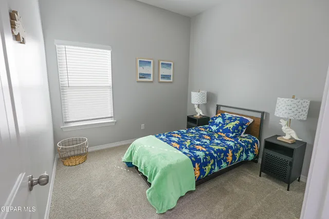 a bedroom with bed and a window