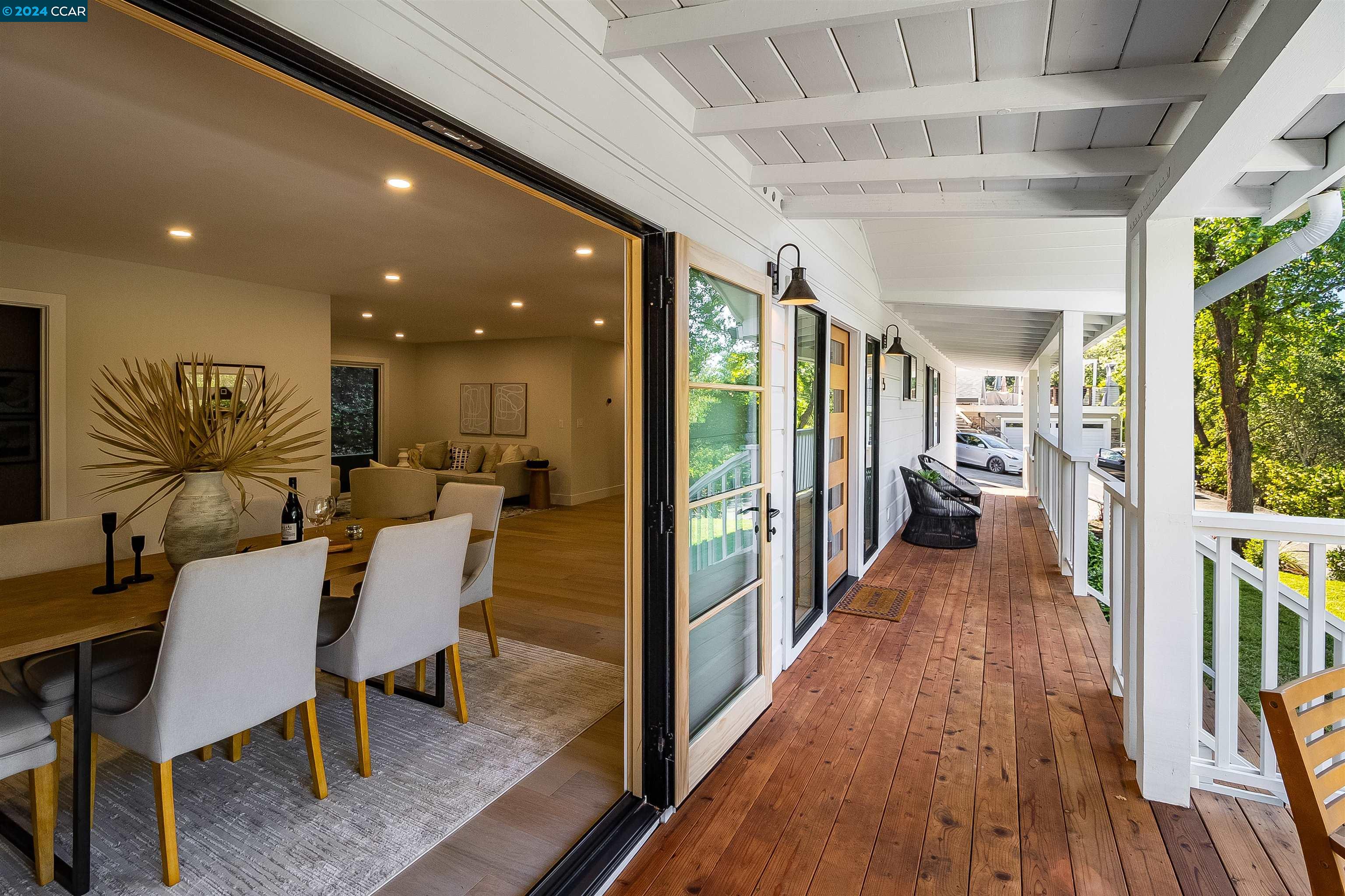 a view of a hallway with furniture and wooden floor