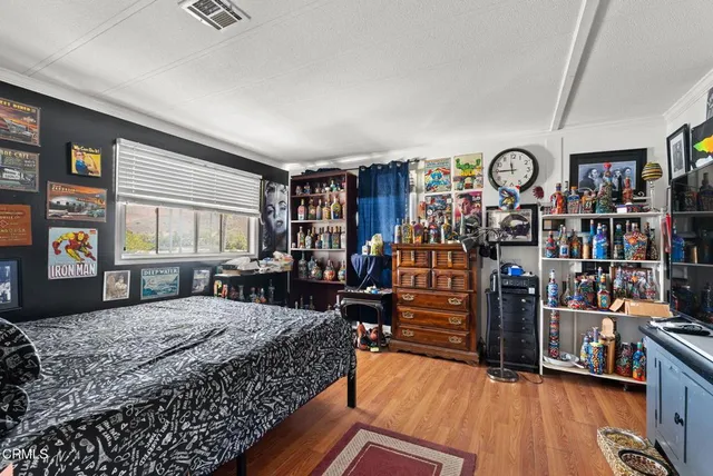 a bedroom with bed and a large window