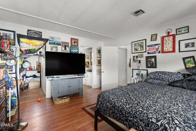 a bedroom with a bed and a flat screen tv