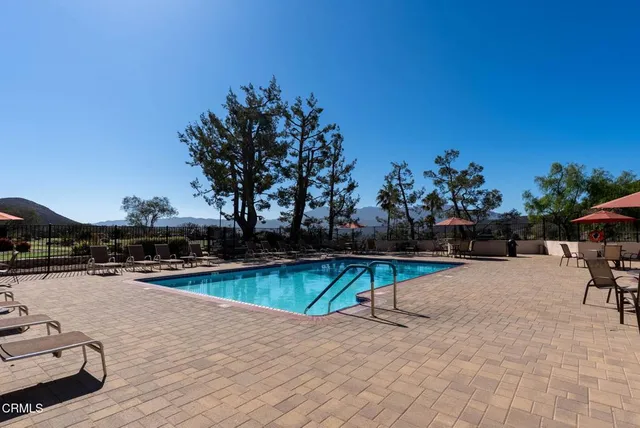 a view of a swimming pool with lounge chair