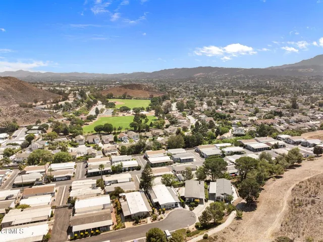 an aerial view of residential houses with city view
