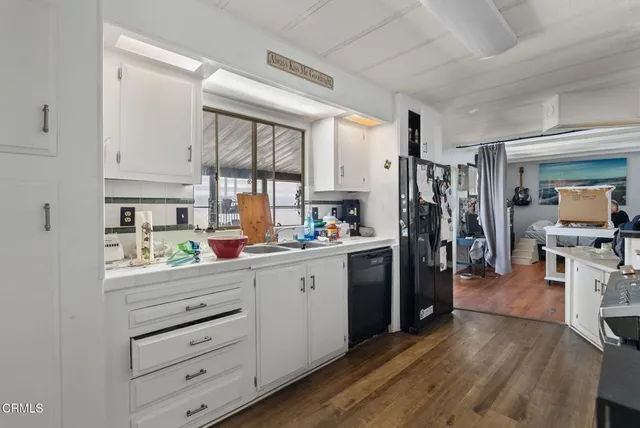 a kitchen with a refrigerator and a stove top oven