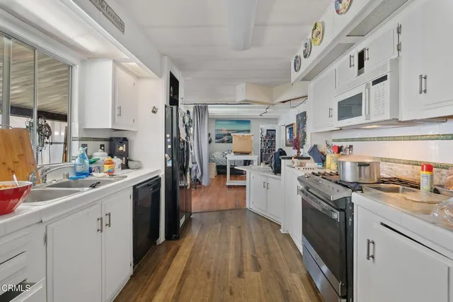 a kitchen with stainless steel appliances granite countertop lots of counter top space sink stove and cabinets