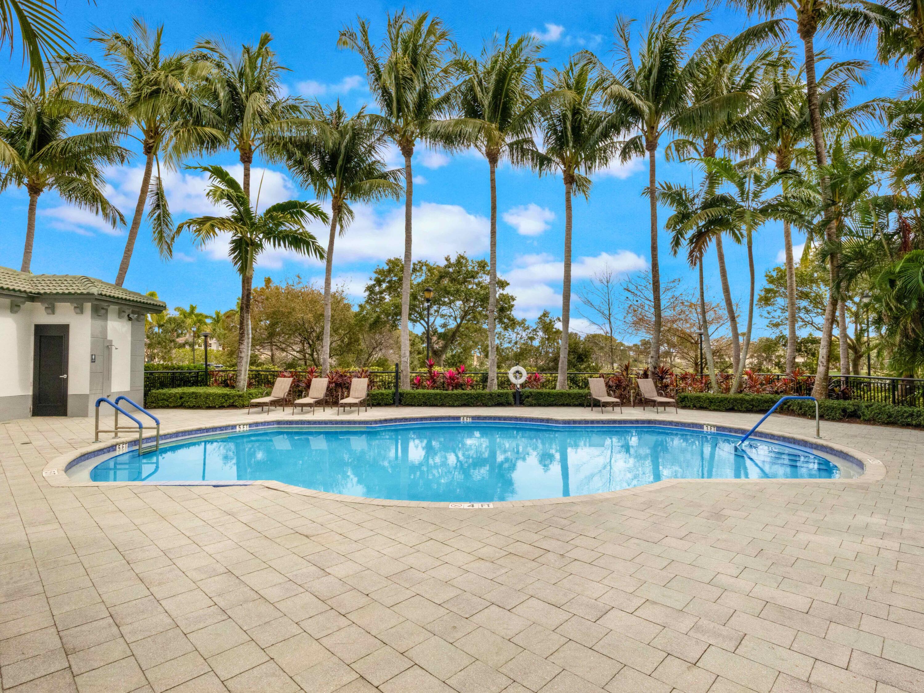 1690 Renaissance Commons Boulevard, Unit 1412 Boynton Beach, FL 33426 - Photo 41 of 49 a view of a swimming pool and a chair