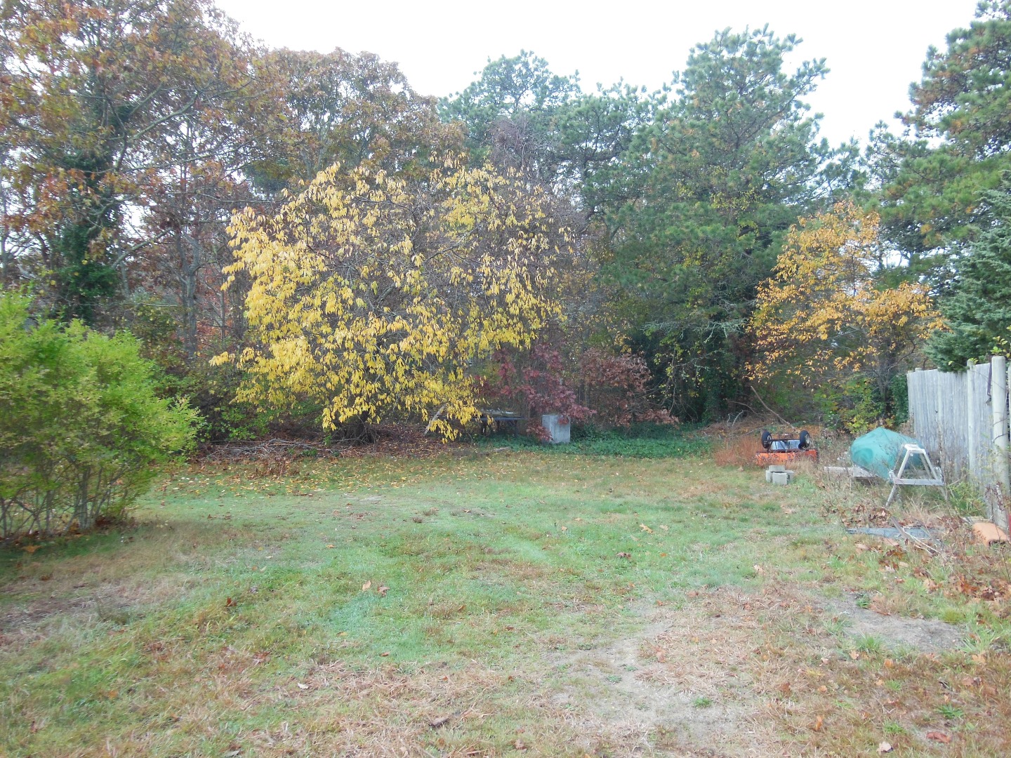 60 West Tisbury Road Edgartown, MA 02539 - Photo 3 of 24 a backyard of a house with table and chairs