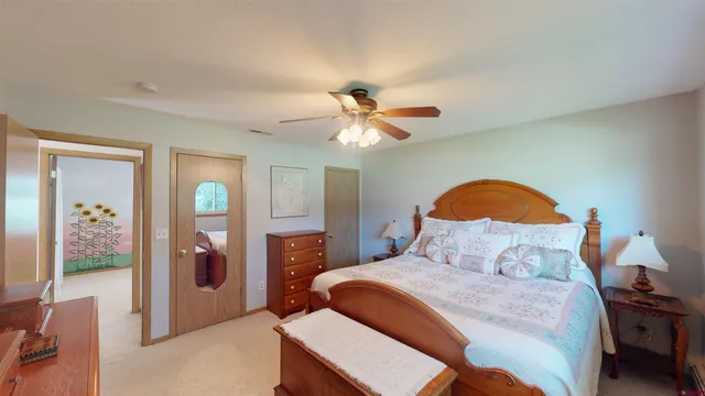 a bedroom with a bed and a chandelier