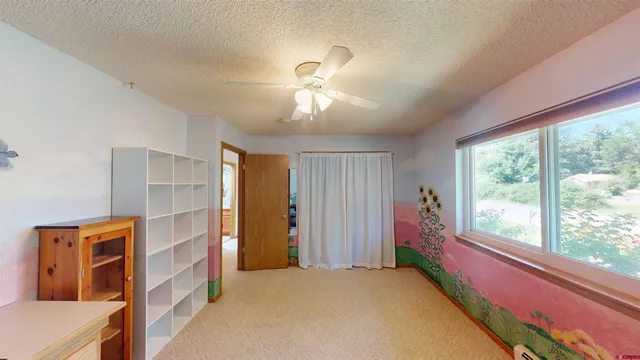 a furnished livingroom with a window and a chandelier