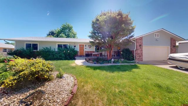a view of a house with backyard sitting area and garden